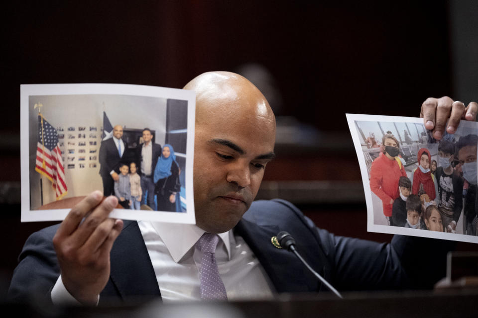 Rep. Colin Allred, D-Texas, holds up photographs of a man evacuated out of Afghanistan as he speaks during a House Committee on Foreign Affairs hearing on the United States evacuation from Afghanistan on Capitol Hill in Washington, Wednesday, March 8, 2023. (AP Photo/Andrew Harnik)