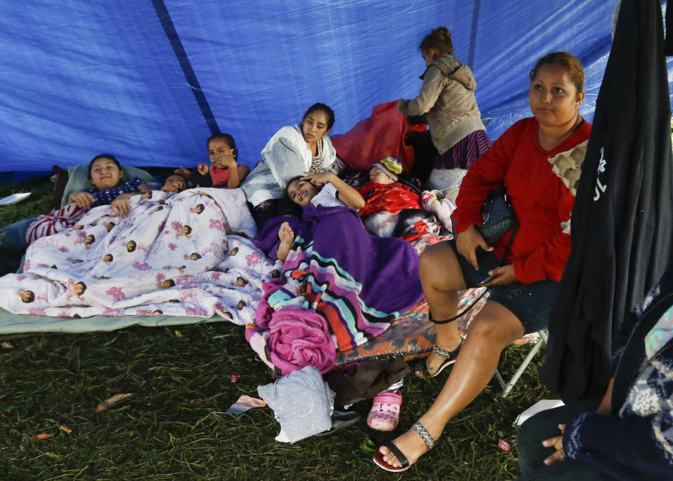 Residents weather Hurricane Eta in a makeshift shelter in Lima, Honduras, Wednesday, Nov. 4, 2020. Eta weakened from the Category 4 hurricane to a tropical storm after lashing the Caribbean coast for much of Tuesday, its floodwaters isolating already remote communities and setting off deadly landslides. (AP Photo/Delmer Martinez)