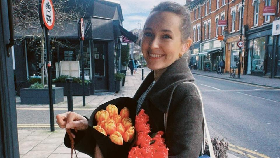 Rose Ayling-Ellis holding bouquet of flowers on London street 