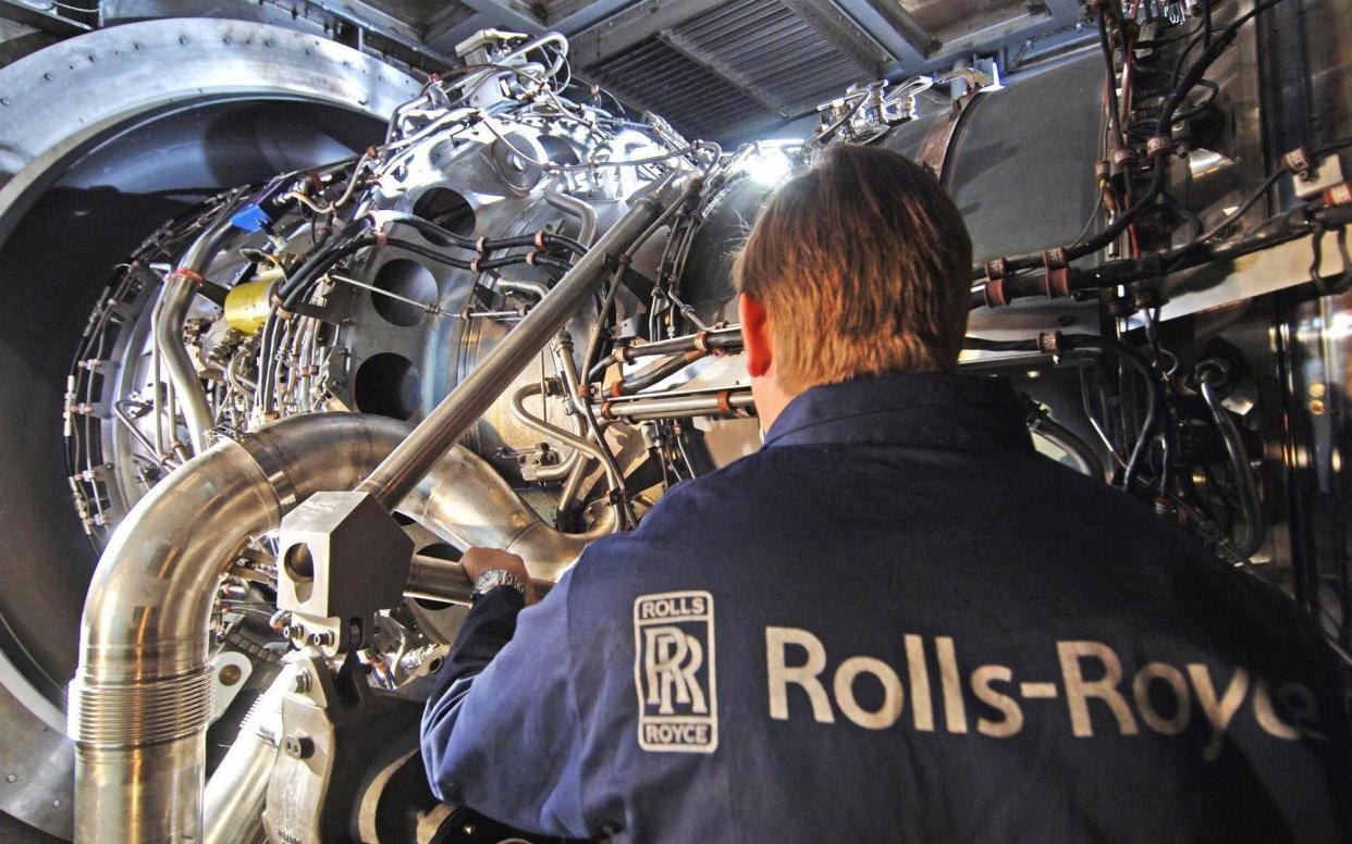 A Rolls-Royce worker with the company's MT30 engine