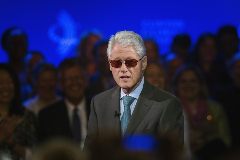 Former U.S. President Bill Clinton does an impression of artist Bono during the Clinton Global Initiative (CGI) in New York September 25, 2013. The CGI was created by Bill Clinton in 2005 to gather global leaders to discuss solutions to the world's problems. REUTERS/Lucas Jackson (UNITED STATES - Tags: POLITICS)