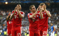 Bayern's Jerome Boateng, Philipp Lahm and Thomas Mueller, from left, acknowledge the fans after losing 0-1 in a Champions League semifinal first leg soccer match between Real Madrid and Bayern Munich at the Santiago Bernabeu stadium in Madrid, Spain, Wednesday, April 23, 2014 .(AP Photo/Paul White)