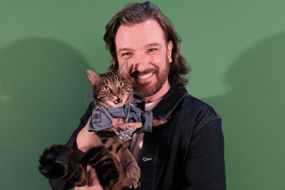 <p>Courtesy of Meow Mix</p> JC Chasez poses with a cat for his latest Meow Mix campaign 