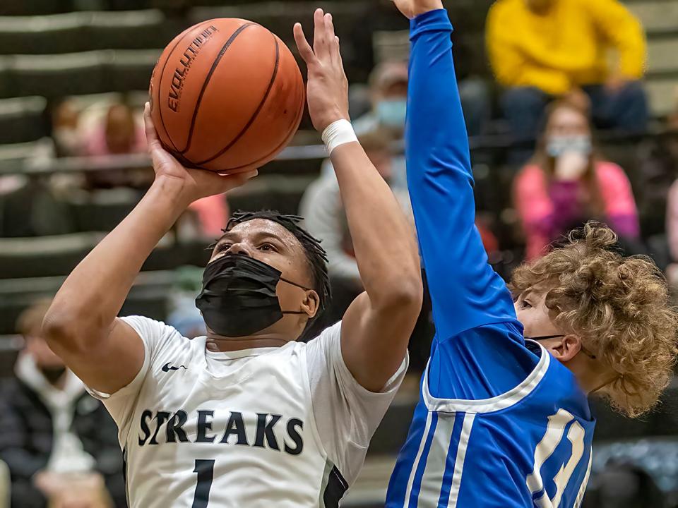 Galesburg High School senior Jeremiah Babers, left, shoots a jumper as Quincy's Ralph Wires defends during the Silver Streaks' 55-53 WB6 Conference loss to the Blue Devils on Friday, Jan. 14, 2022.