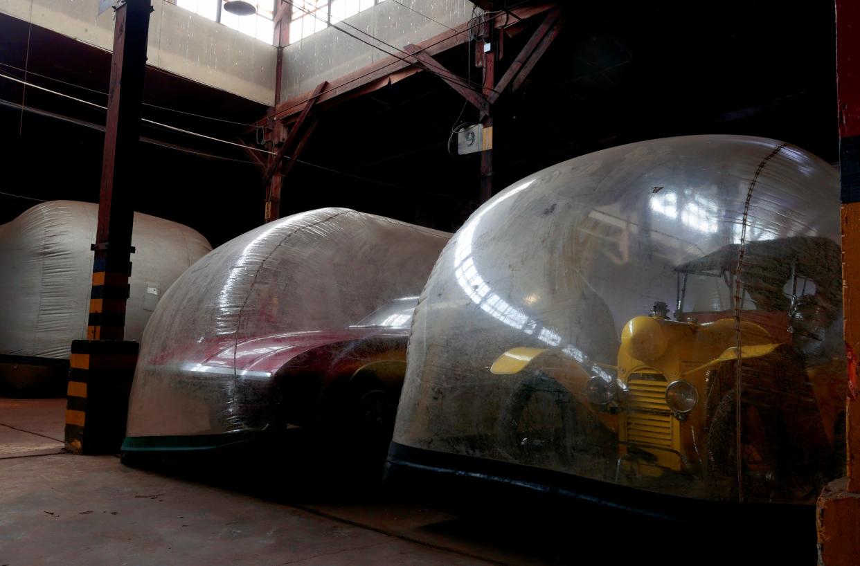 A 1963 Ford Cougar II Prototype built on a Shelby Cobra chassis and a 1914 Scripps-Booth "Rocket" cycle car sit inside plastic inflatable bubbles to keep them protected at the large warehouse at the Detroit Historical Society's Collections Resource Center in Detroit on Thursday, November 2, 2023.