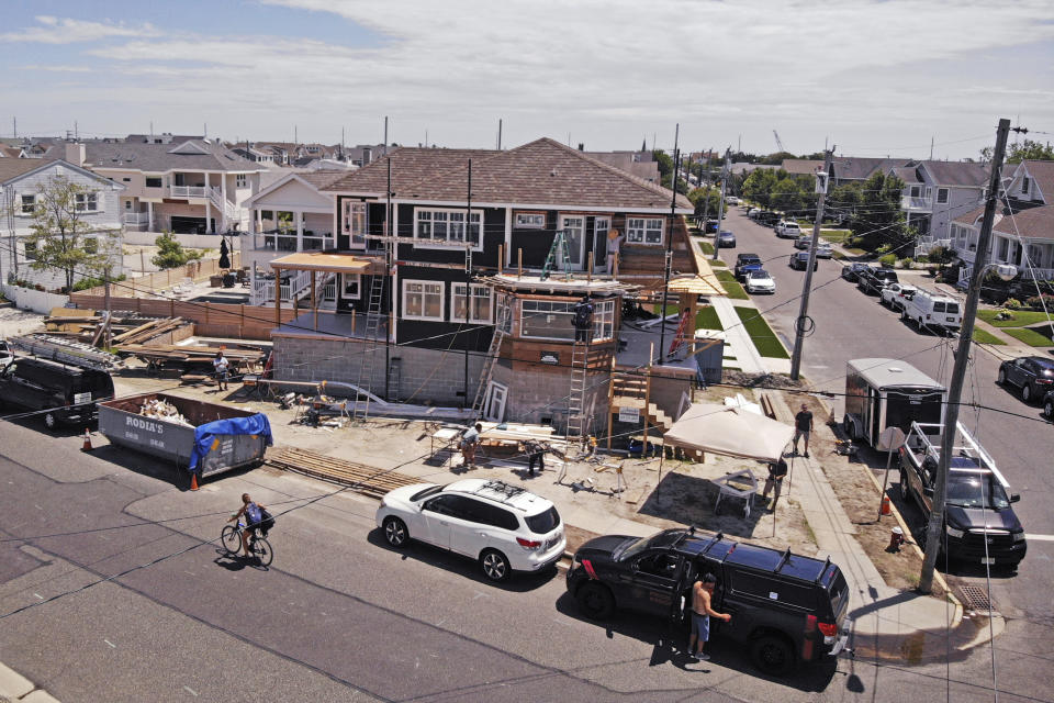 In this image from a drone, workers construct a new house elevated with cinder blocks in Stone Harbor, N.J., on Thursday, July 23, 2020. (AP Photo/Ted Shaffrey)