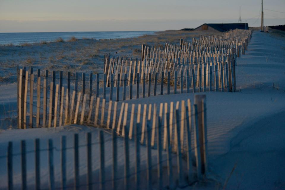 The early morning sun rises over Nauset Beach, in Orleans on March 31.