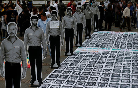 Pictures of missing people and victims of the armed conflict are displayed during celebrations for a year of peace signing in Bogota, Colombia November 24, 2017. REUTERS/Jaime Saldarriaga