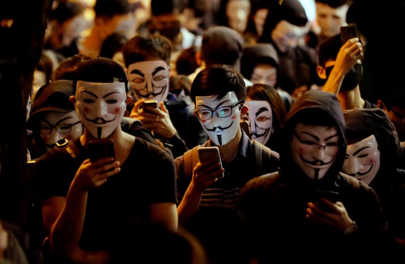 Protesters wearing Guy Fawkes masks attend an anti-government demonstration in Hong Kong