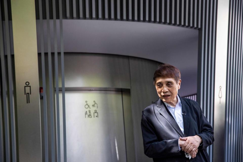 Japanese architect Tadao Ando poses in front of a public toilet designed by him ahead of  