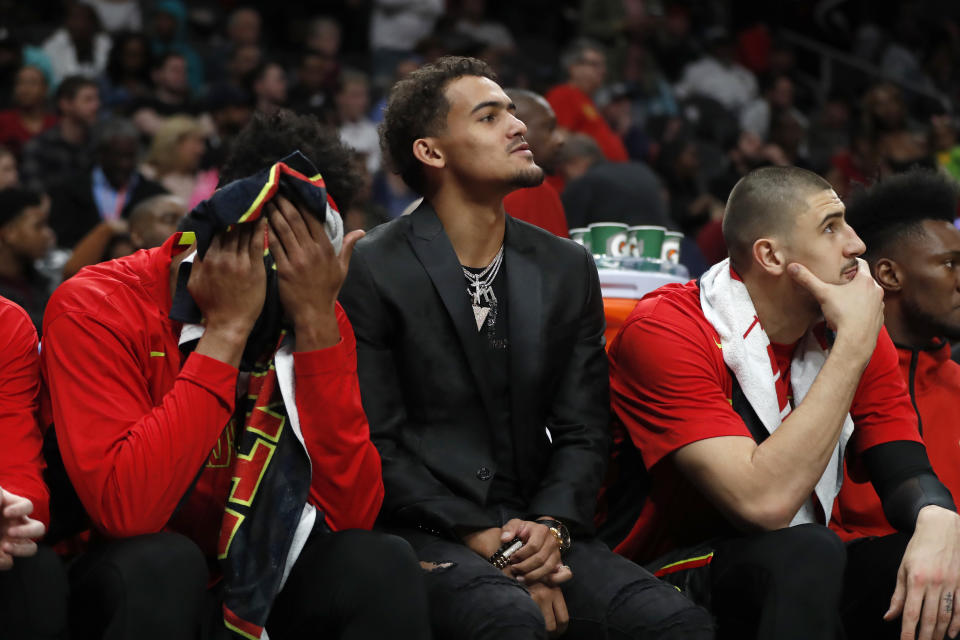 Injured Atlanta Hawks guard Trae Young sits on the bench during the second half of the team's NBA basketball game against the Miami Heat on Thursday, Oct. 31, 2019, in Atlanta. Miami won 106-97. (AP Photo/John Bazemore)