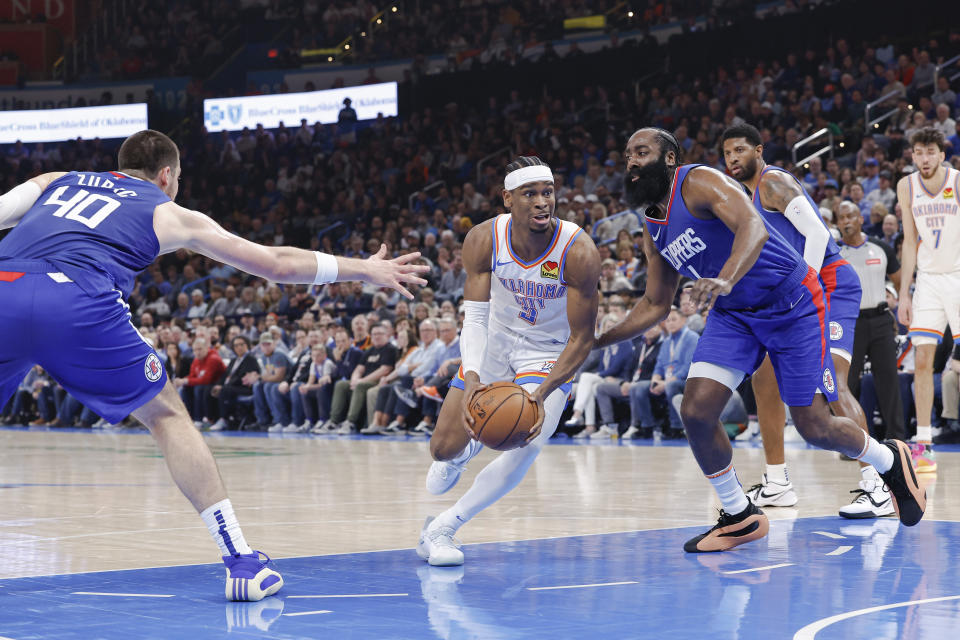 Feb 22, 2024; Oklahoma City, Oklahoma, USA; Oklahoma City Thunder guard Shai Gilgeous-Alexander (2) moves between LA Clippers guard James Harden (1) and center <a class="link " href="https://sports.yahoo.com/nba/players/5663/" data-i13n="sec:content-canvas;subsec:anchor_text;elm:context_link" data-ylk="slk:Ivica Zubac;sec:content-canvas;subsec:anchor_text;elm:context_link;itc:0">Ivica Zubac</a> (40) during the second quarter at Paycom Center. Mandatory Credit: Alonzo Adams-USA TODAY Sports