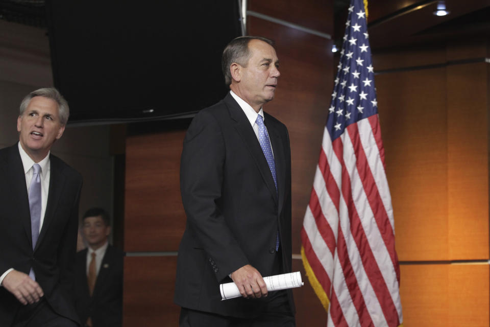 House Speaker John Boehner of Ohio, right, followed by Majority Whip Kevin McCarthy of Calif., left, arrives to speak to reporters about the debt crisis showdown during a news conference on Capitol Hill in Washington, Thursday, July 28, 2011. (AP Photo/J. Scott Applewhite)