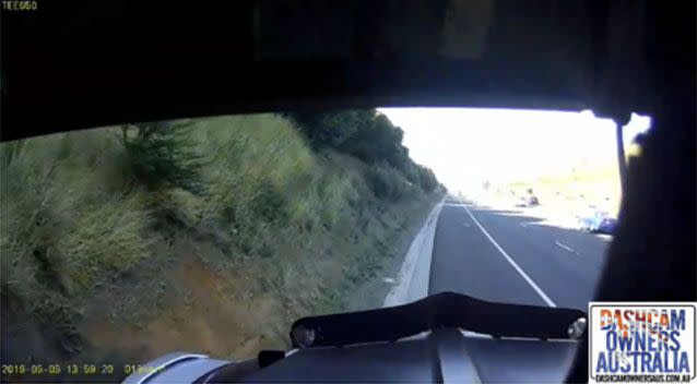 The trapped car is dragged about 100m as the truck finds a safe place to pull over. Picture: Dash Cam Owners Australia/Facebook