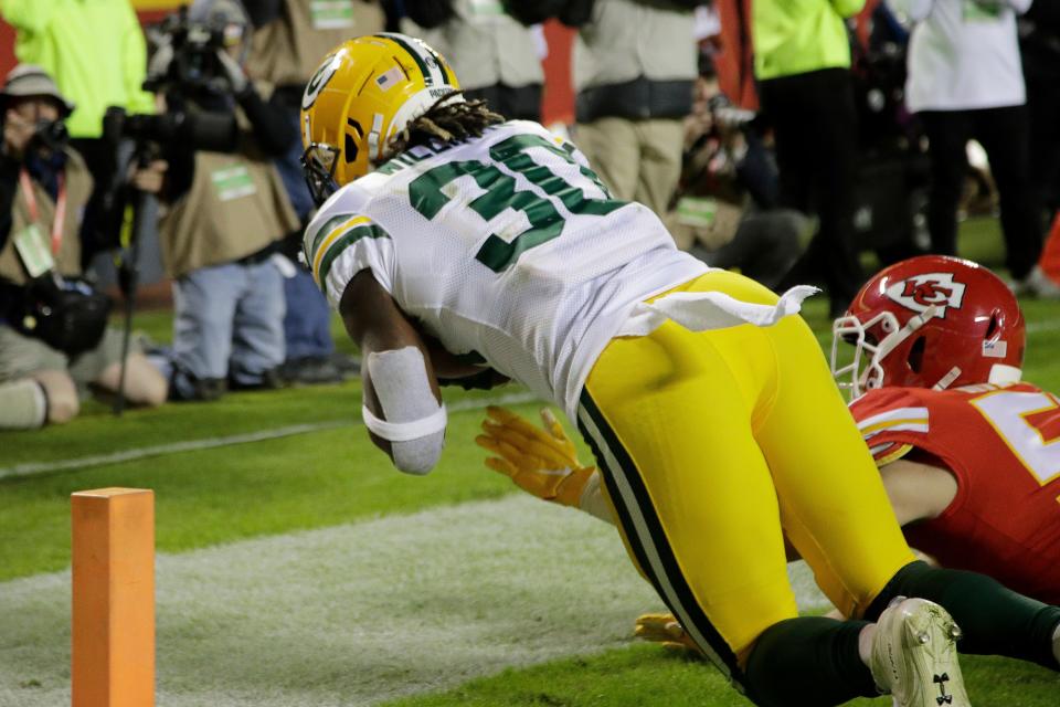 Green Bay Packers running back Jamaal Williams (30) scores a touchdown off a throw by quarterback Aaron Rodgers against Kansas City Chiefs linebacker Ben Niemann (56) during the second half of an NFL football game against the Kansas City Chiefs in Kansas City, Mo., Sunday, Oct. 27, 2019.