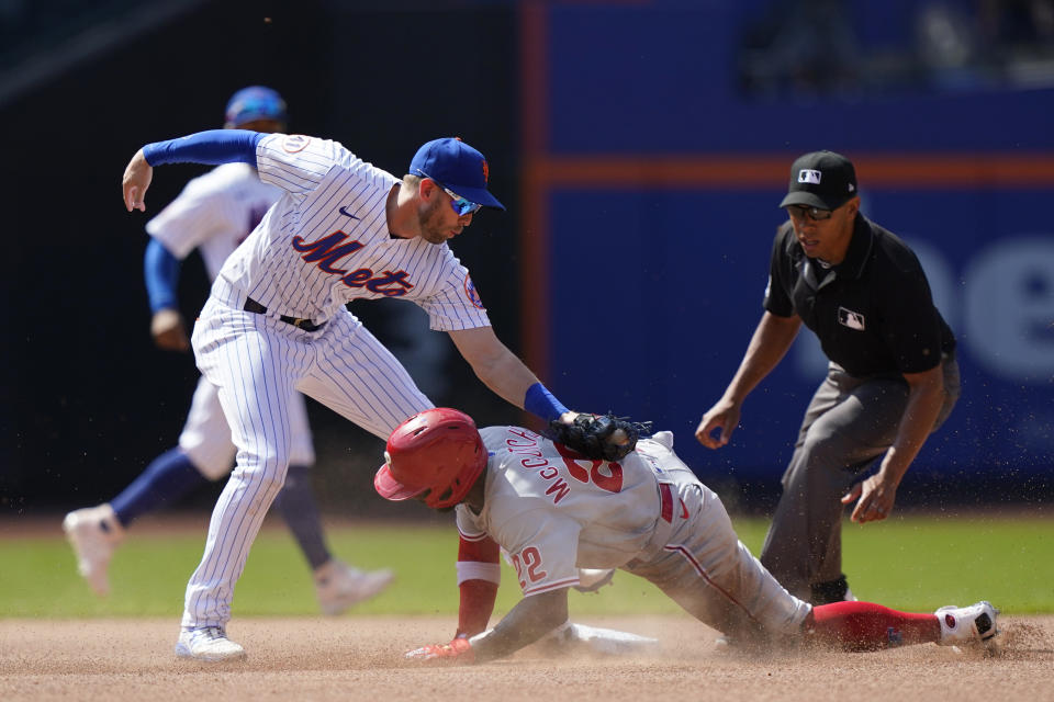 New York Mets second baseman Jeff McNeil (6) tags Philadelphia Phillies Andrew McCutchen (22) out at second base during the seventh inning of a baseball game, Sunday, June 27, 2021, in New York. McCutchen was ruled safe on the field but the call was reversed after a video review. (AP Photo/Kathy Willens)