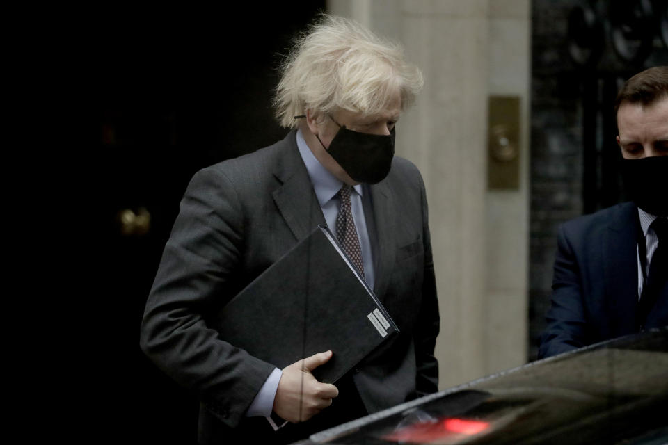 British Prime Minister Boris Johnson leaves 10 Downing Street to go to the Houses of Parliament, in London, Monday, Feb. 22, 2021. Johnson on Monday is expected to announce a plan to ease coronavirus restrictions in increments, starting by reopening schools in England on March 8. (AP Photo/Matt Dunham)