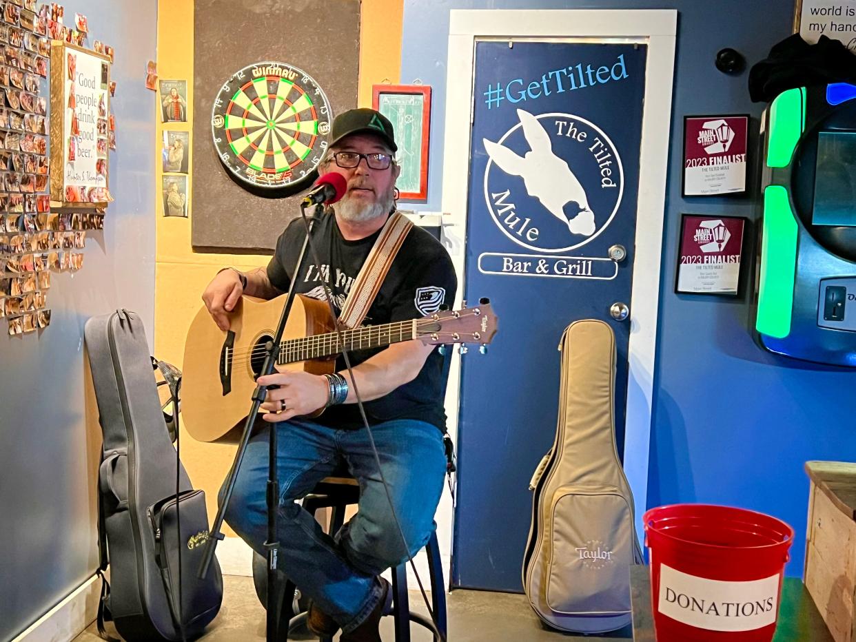 U.S. Army vet Malachais Gaskin hosts the Stop 22 veterans' open mic at The Tilted Mule in Columbia, inviting veterans, families and military supporters to sing, tell stories and express fellowship every month.