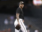 Arizona Diamondbacks outfielder David Peralta smiles after striking out Washington Nationals' Yadiel Hernandez during the ninth inning of a baseball game Friday, May 14, 2021, in Phoenix. (AP Photo/Darryl Webb)