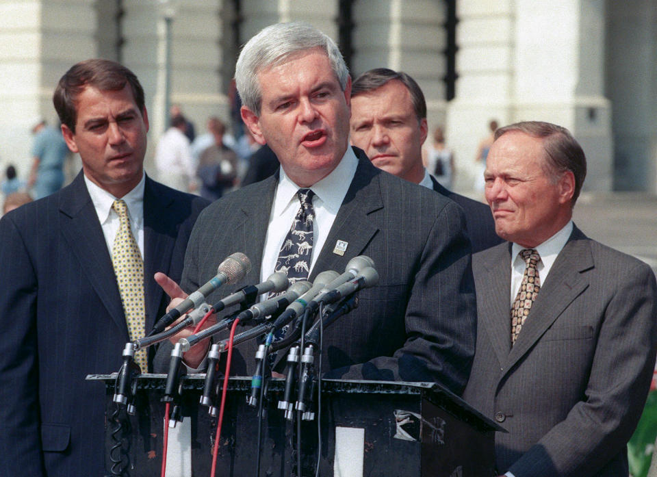 FILE - Speaker of the House, Newt Gingrich, talks about the passage of a $80 billion, five-year tax cut during a news conference on Capital Hill Saturday, Sept 26, 1998. At left is Rep. John Boehner, R-Ohio, Rep. Christopher Cox, R-Calif., and Rep. Bill Archer, left, R-Texas. (AP Photo/Leslie Kossoff, File)