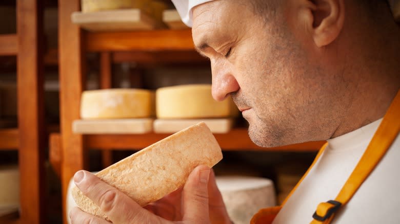 man smelling cheese