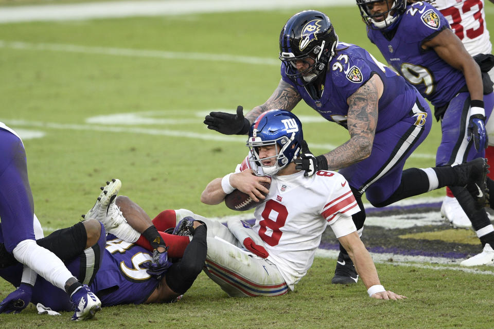 New York Giants quarterback Daniel Jones (8) is sacked by Baltimore Ravens linebacker Chris Board, let, as defensive end Derek Wolfe (95) helps bring him down during the second half of an NFL football game, Sunday, Dec. 27, 2020, in Baltimore. The Ravens won 27-13. (AP Photo/Nick Wass)