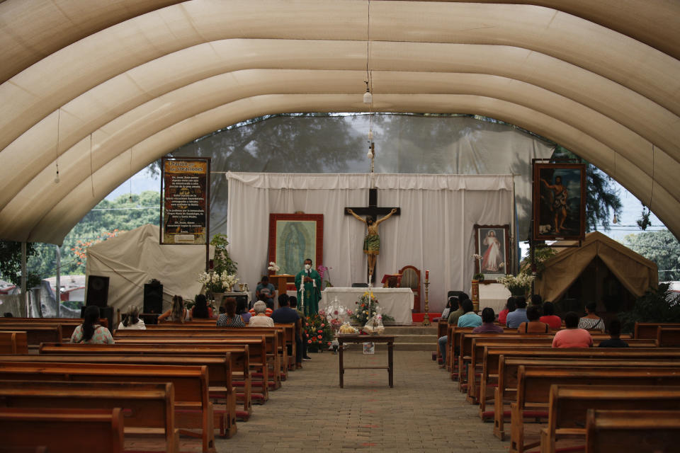 Father Filiberto Arias Araujo leads an afternoon Mass in a temporary outdoor chapel erected outside the former San Juan Bautista Convent, where restoration work is underway following damage in a 2017 earthquake, in Tlayacapan, Morelos State, Mexico, Tuesday, Oct. 13, 2020. Araujo explained the importance of the bells in Mexican village life: that church bells are commonly rung as an alarm in emergencies, or toll to gather townspeople together. (AP Photo/Rebecca Blackwell)