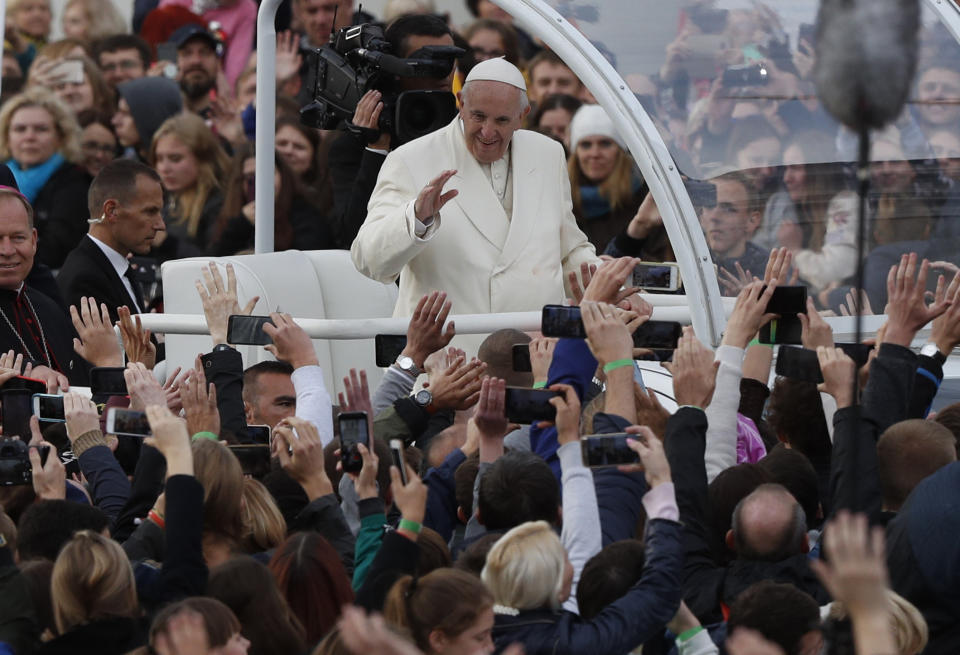 Pope Francis greets the crowd on his Popemobile as he arrives for a meeting with youths at the Cathedral Square in Vilnius, Lithuania, Saturday Sept. 22, 2018. (AP Photo/Mindaugas Kulbis)