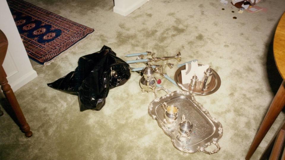 Valuables, including a silver tea set, were scattered across the floor in the Krauseneck family's home.  / Credit: Monroe County District Attorney's Office 