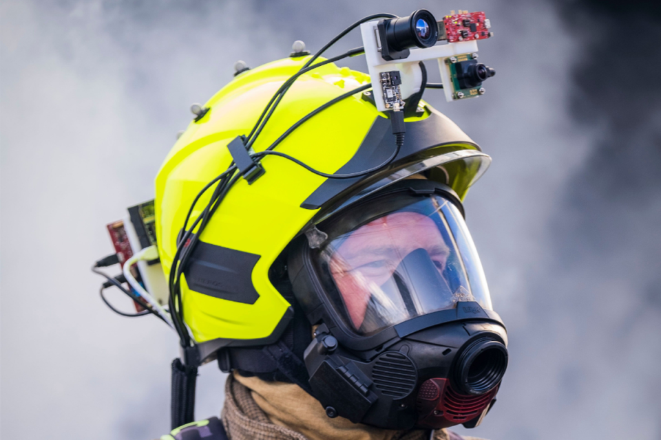 A firefighter wears a helmet enhanced with sensors and cameras allowing them to locate victims more quickly (Craig Watt/PA) (Craig Watt)