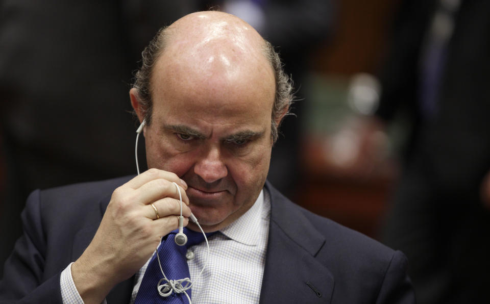 Spain's Economy Minister Luis de Guindos speaks on his phone during a meeting of EU finance ministers at the EU Council building in Brussels on Tuesday, March 13, 2012. The decision to give Spain some more leeway on cutting this year's deficit is already triggering demands for more fiscal leniency for other European countries. Finance ministers from the eurozone said Monday that Spain will be allowed to run a deficit of 5.3 percent of gross domestic product this year, above the original 4.4 percent target. (AP Photo/Virginia Mayo)