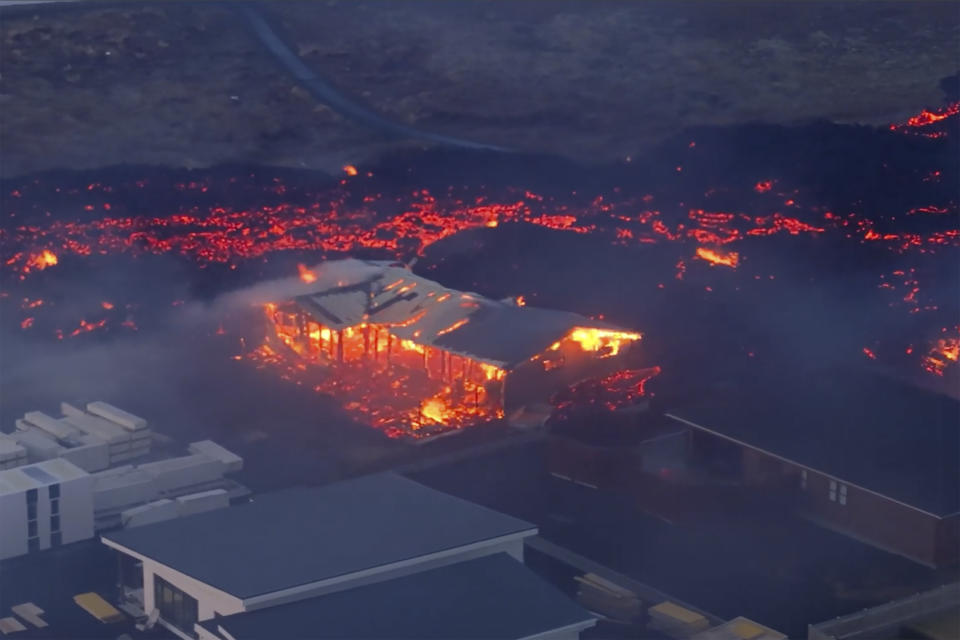 In this image made from video, volcanic activity is seen in Grindavik, Iceland, Sunday, Jan. 14, 2024. Iceland’s president says the country is battling “tremendous forces of nature” after molten lava from a volcano consumed several houses in the evacuated town of Grindavik. (Bjorn Steinbekk via AP)