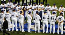 <p>Current players stand and applaud as Los Angeles Dodgers Hall of Fame broadcaster Vin Scully, center ( in blue suit), leaves the field after being honored in a ceremony before a baseball game against the Colorado Rockies at Dodger Stadium Friday, Sept. 23, 2016. (AP Photo/Reed Saxon) </p>