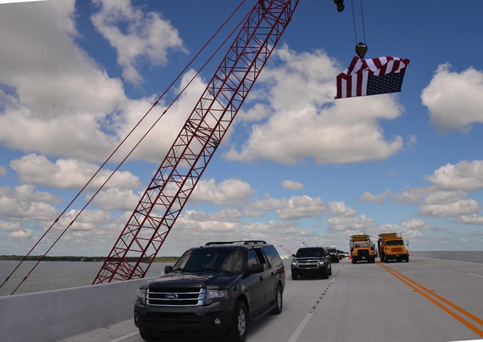 Florida Lt. Gov. Jeanette Nuñez's sport-utility vehicle leads a procession across the newly completed bridge Friday morning at the NASA Causeway.