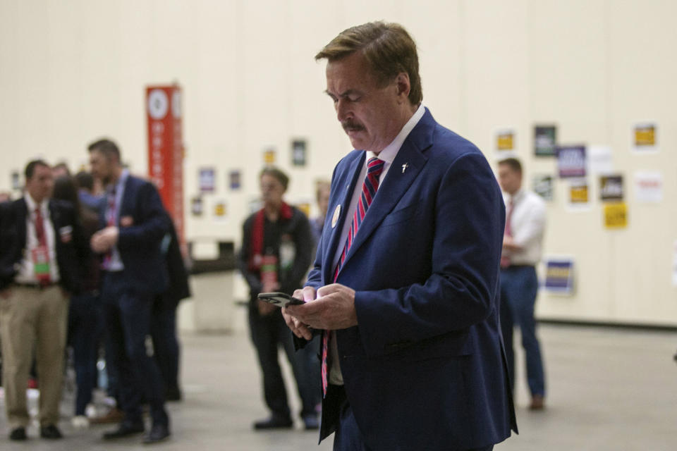FILE - Mike Lindell, CEO of My Pillow, looks down at his phone before taking the stage during the Michigan Republican Convention at Devos Place in Grand Rapids, Mich., April 23, 2022. On Monday, April 15, 2024, the U.S. Supreme Court denied a petition by the MyPillow founder and election denier to consider his challenge to legality of the FBI's seizure of his cell phone at a restaurant drive-through. (Daniel Shular/The Grand Rapids Press via AP, File)