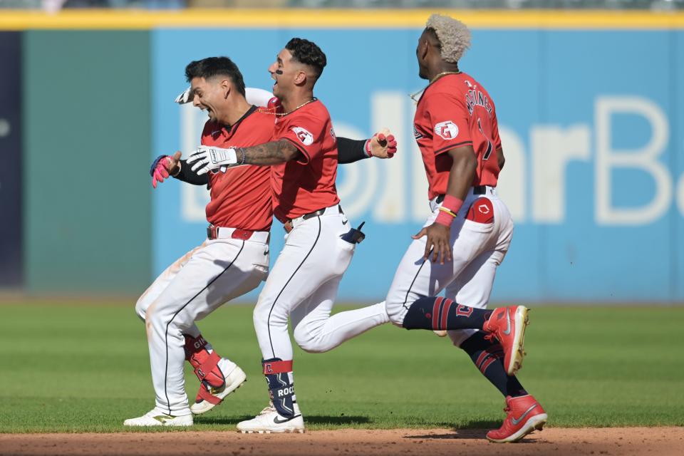 Sep 19, 2024; Cleveland, Ohio, USA; Cleveland Guardians second baseman Andres Gimenez (0) celebrates with shortstop Brayan Rocchio (4) and left fielder Angel Martinez (1) after getting the game-winning hit during the tenth inning against the Minnesota Twins at Progressive Field. With the win the Guardians clinched a playoff berth. Mandatory Credit: Ken Blaze-Imagn Images