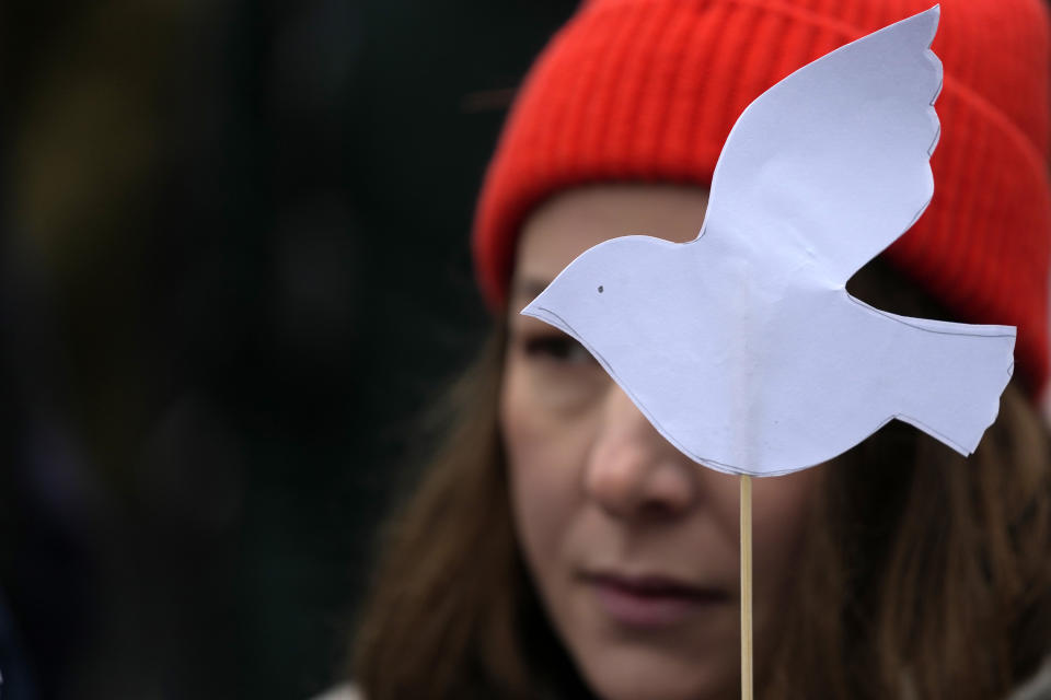 A woman holds a white pigeon, a symbol of peace during a rally in support of Russia's political prisoners in Belgrade, Serbia, Saturday, Jan. 21, 2023. A friendly, fellow-Slavic nation, Serbia has welcomed the fleeing Russians who need visas to travel to much richer Western European states. But in Serbia, they have not escaped the long reach of Putin's hardline regime influence.(AP Photo/Darko Vojinovic)