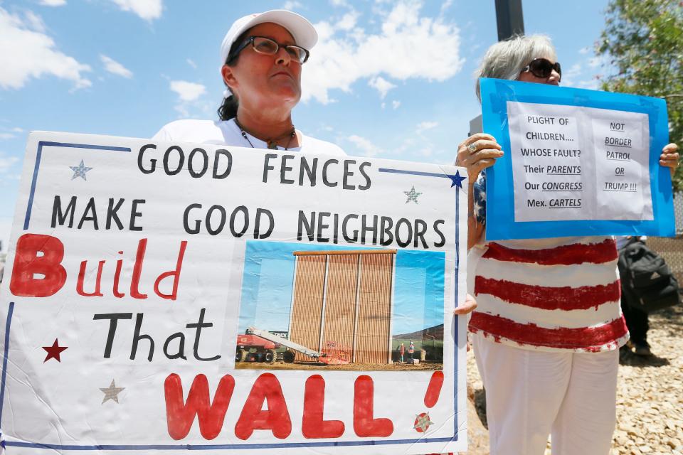 Melanie Brooks and Diane Otten hold signs outside the Clint Border Patrol station Monday, July 1, at the station in Clint. Protesters gathered to hear U.S. and Texas lawmakers talk about what they thought of the area facilities they toured.