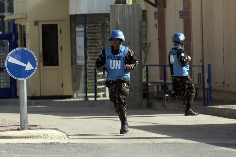 Filipino UN peacekeepers cross the Quneitra checkpoint between Israel and Syria in the Golan Heights on March 9, 2013. A group of 21 UN peacekeepers seized by Syrian rebels on the Golan were still being held on Saturday after a two-hour truce during which their release had been expected, a watchdog said