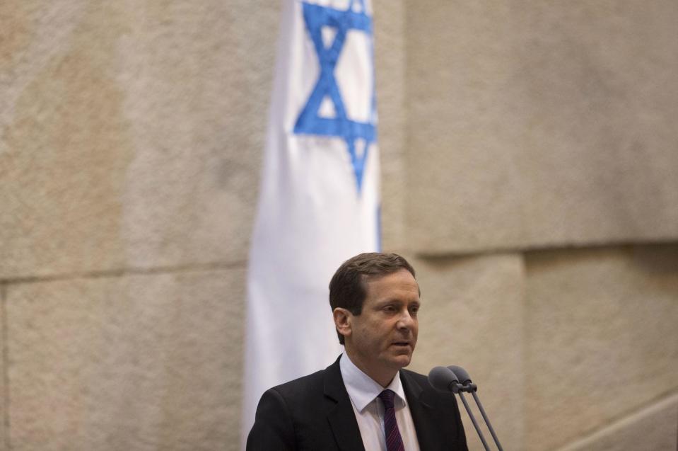 In this photo taken on Monday, Jan. 20, 2014, Israel’s opposition leader and Labor Party leader Isaac Herzog speaks at the Knesset, Israel's Parliament, in Jerusalem. Israel’s opposition leader said Tuesday that Prime Minister Benjamin Netanyahu fully appreciates the wisdom of making peace with the Palestinians. He’s just not sure he has the “guts.” Herzog, who was elected head of the Labor Party in November, said that his ultimate goal is to replace Netanyahu. But he said he would back the prime minister if he genuinely pursues peace with the Palestinians and offered a political “safety net” should Netanyahu’s right-leaning coalition rebel in case of substantial progress in recently restarted peace talks.(AP Photo/Ariel Schalit)