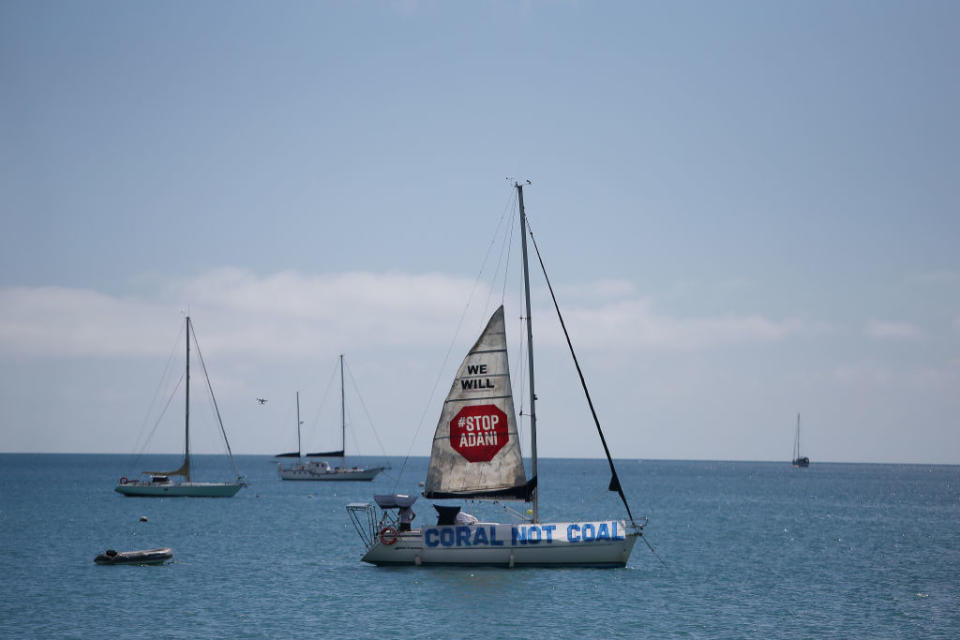 A boat launches a sail in protest to the Adani Carmichael Coal Mine proposal in Airlie Beach, Australia on April 26, 2019.<span class="copyright">Lisa Maree Williams—Getty Images</span>