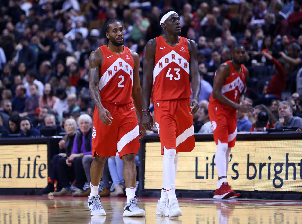 TORONTO, ON - DECEMBER 30:  Kawhi Leonard #2 and Pascal Siakam #43 of the Toronto Raptors walk onto the court during the second half of an NBA game against the Chicago Bulls at Scotiabank Arena on December 30, 2018 in Toronto, Canada.  NOTE TO USER: User expressly acknowledges and agrees that, by downloading and or using this photograph, User is consenting to the terms and conditions of the Getty Images License Agreement.  (Photo by Vaughn Ridley/Getty Images)