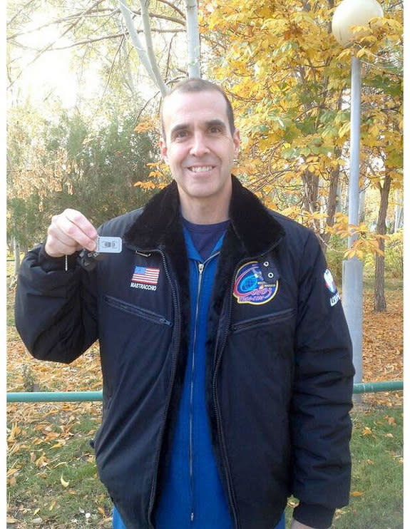 NASA astronaut Rick Mastracchio holding the geocaching travel bug he will fly to the International Space Station, Oct. 26, 2013.