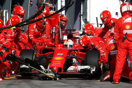 Formula One - F1 - Australian Grand Prix - Melbourne, Australia - 26/03/2017 Ferrari driver Sebastian Vettel of Germany has a tyre change during the Australian Formula One Grand Prix. REUTERS/Brandon Malone