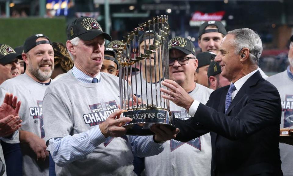 Rob Manfred presents Atlanta Braves chairman Terry McGuirk with a piece of metal