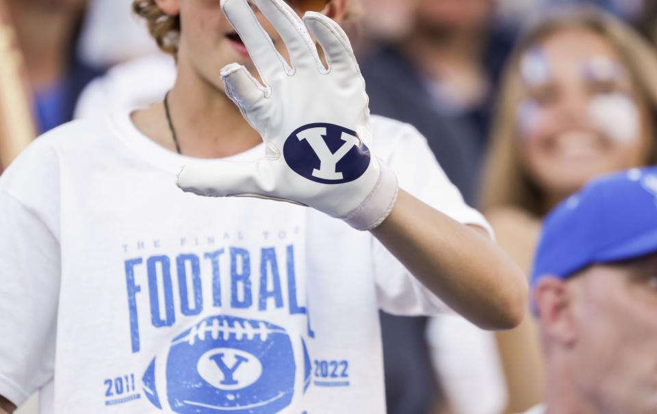 A fan shows his BYU glove for photo during a football game at LaVell Edwards Stadium in Provo on Saturday, Oct. 15, 2022.