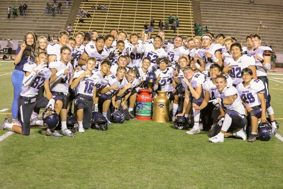 The Piedra Vista Panthers celebrate their season opening 53-31 win over Farmington, reclaiming the Milk Jug, the unofficial trophy for beating their crosstown rivals, Friday, Aug. 19, 2022 at Hutchison Stadium.