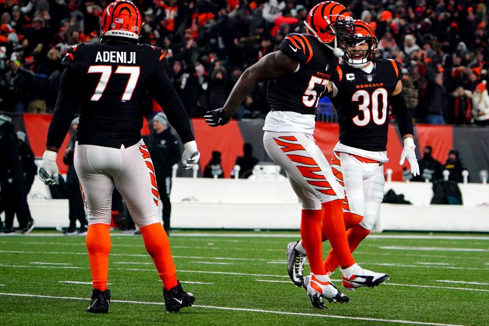 Cincinnati Bengals linebacker Germaine Pratt (57) and the Cincinnati Bengals defense celebrate PrattÕs interception to seal with win in the fourth quarter during an NFL AFC wild-card playoff game, Saturday, Jan. 15, 2022, at Paul Brown Stadium in Cincinnati.  The Cincinnati Bengals defeated the Las Vegas Raiders, 26-19 to win the franchise's first playoff game in 30 years.