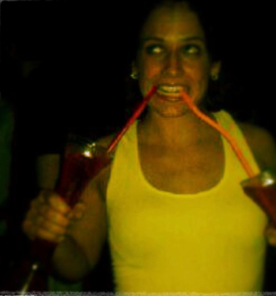 Amanda Berkey drinking two cocktails at the same time when she was younger