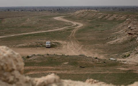 The village of Bagouz, Isil's ;ast enclave, is seen from an SDF hilltop position on February 14 - Credit: Getty Images Europe/Chris McGrath